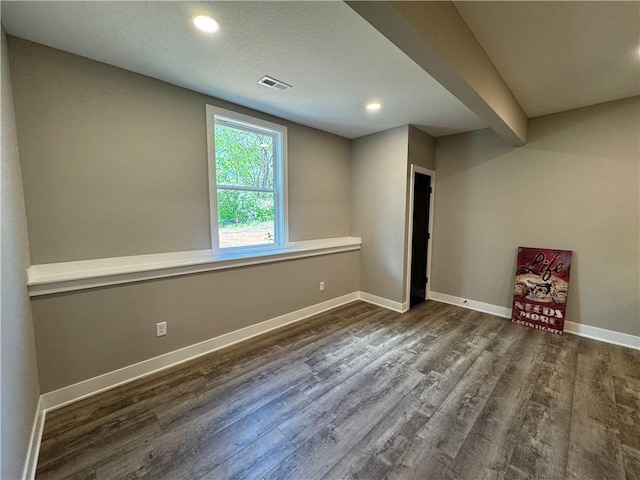 basement featuring baseboards, recessed lighting, wood finished floors, and visible vents