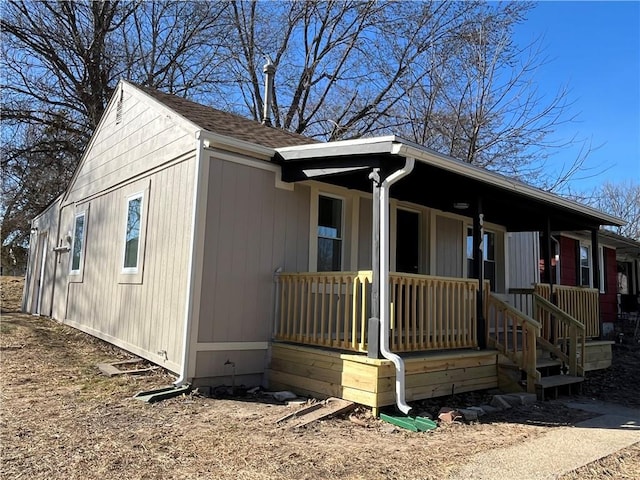 view of front facade featuring a porch and roof with shingles