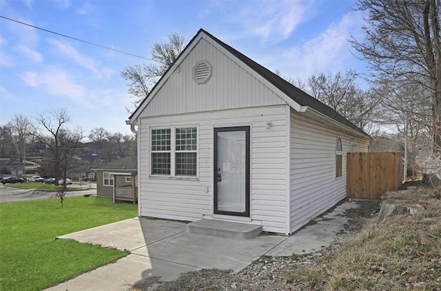 view of outbuilding featuring fence