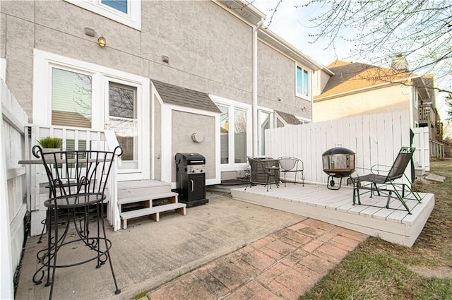 view of patio / terrace with area for grilling and fence