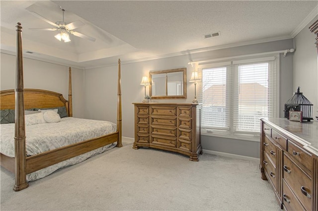 bedroom with visible vents, light carpet, a tray ceiling, a textured ceiling, and baseboards