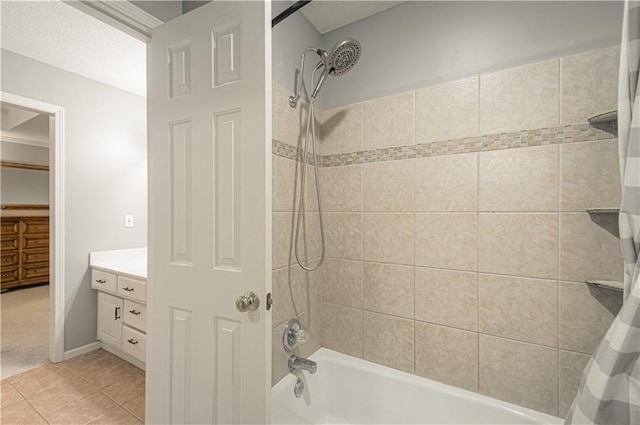 bathroom featuring tile patterned floors, vanity, and shower / bath combo