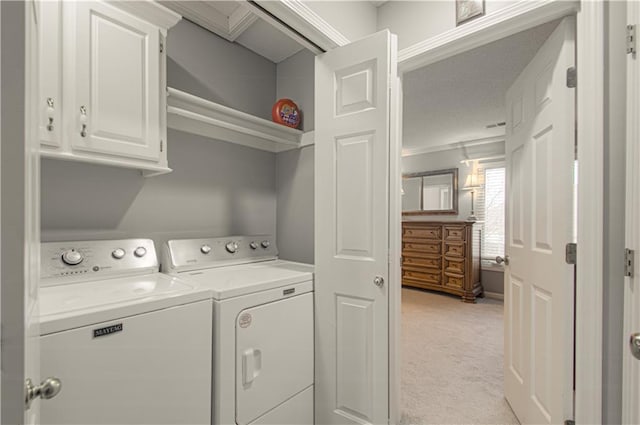 laundry area featuring cabinet space, separate washer and dryer, and light carpet