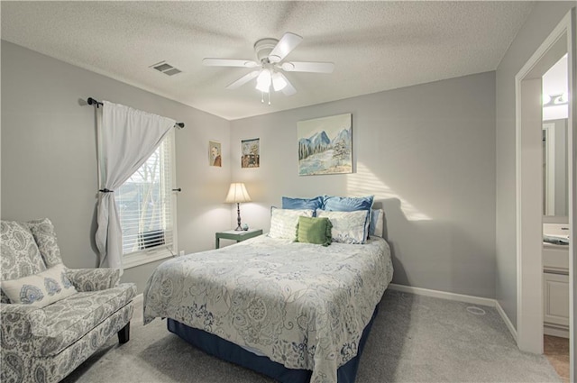 carpeted bedroom featuring visible vents, a textured ceiling, baseboards, and a ceiling fan