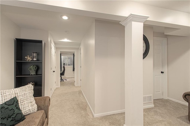 hall featuring visible vents, baseboards, light colored carpet, decorative columns, and recessed lighting