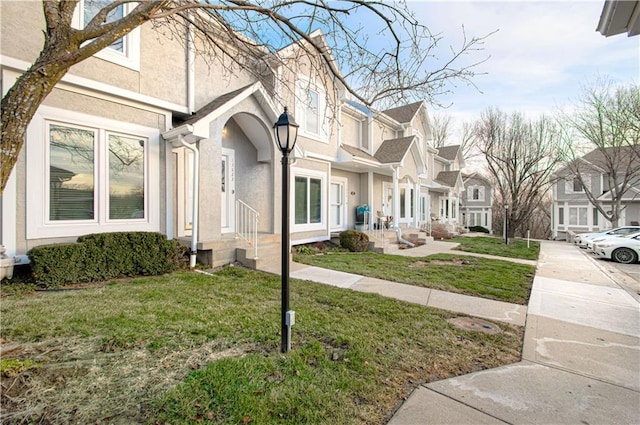 exterior space with a front lawn, a residential view, and stucco siding