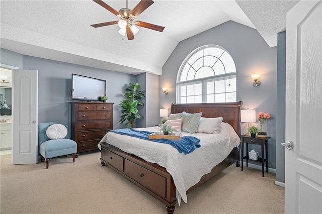 bedroom with a textured ceiling, light colored carpet, a ceiling fan, and vaulted ceiling