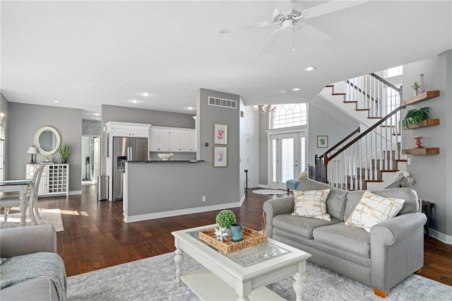 living area with visible vents, ceiling fan, baseboards, stairs, and dark wood-style flooring