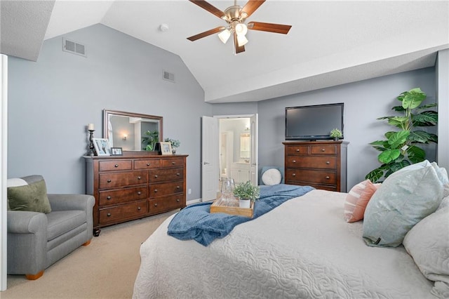 carpeted bedroom with lofted ceiling, a ceiling fan, visible vents, and ensuite bathroom