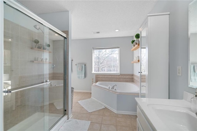 full bath with visible vents, tile patterned flooring, a shower stall, a textured ceiling, and a garden tub