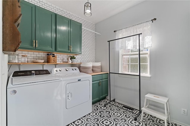 laundry area with washer and dryer, light tile patterned floors, cabinet space, and baseboards