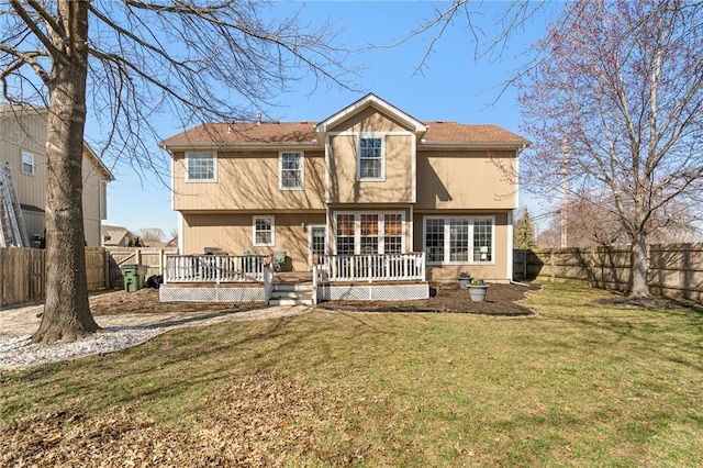 rear view of house featuring a yard, a fenced backyard, and a wooden deck