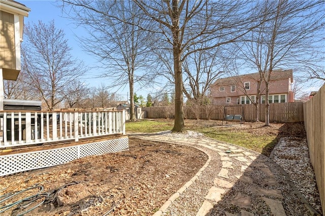 view of yard with a fenced backyard and a wooden deck