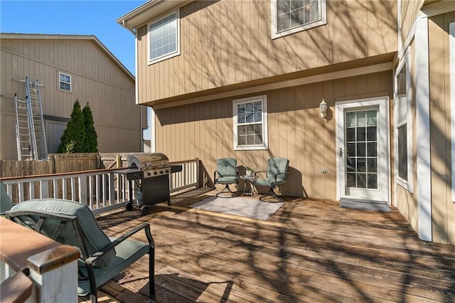 wooden deck featuring area for grilling and fence