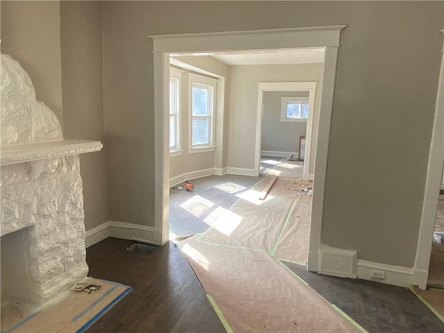 hall featuring wood finished floors and baseboards