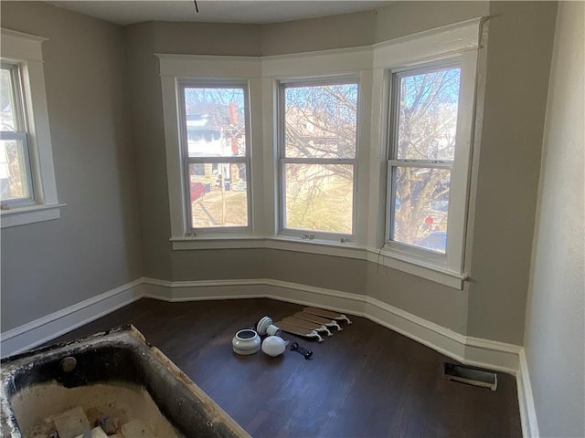 interior space featuring baseboards, visible vents, and dark wood-style flooring