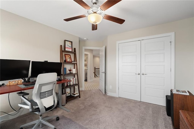 office area with carpet floors and a ceiling fan