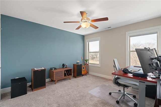 carpeted home office featuring visible vents, ceiling fan, and baseboards