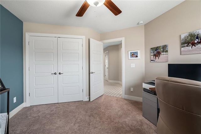 office area with baseboards, a ceiling fan, and carpet floors