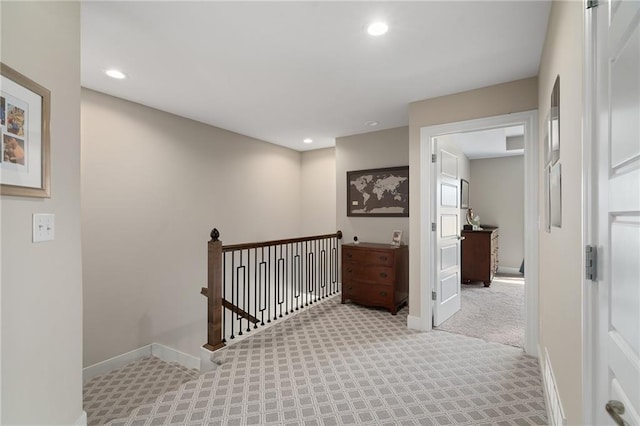 hallway featuring carpet flooring, recessed lighting, an upstairs landing, and baseboards