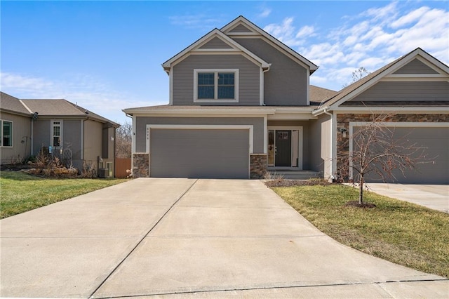 craftsman house featuring central AC unit, a front lawn, stone siding, and concrete driveway