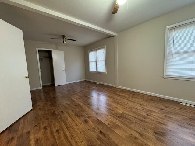 unfurnished room featuring visible vents, baseboards, a ceiling fan, and wood finished floors