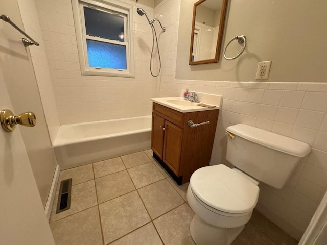 full bathroom featuring tile patterned floors, visible vents, toilet, and tile walls