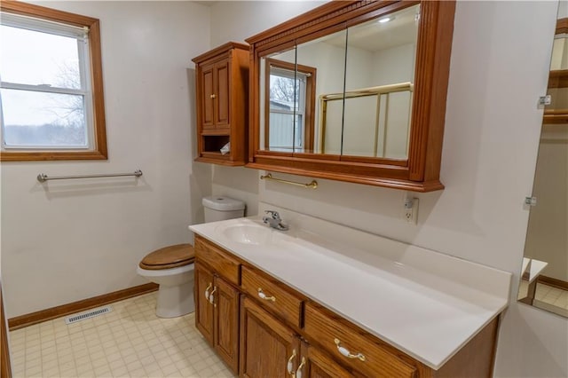 bathroom with vanity, baseboards, visible vents, tile patterned floors, and toilet