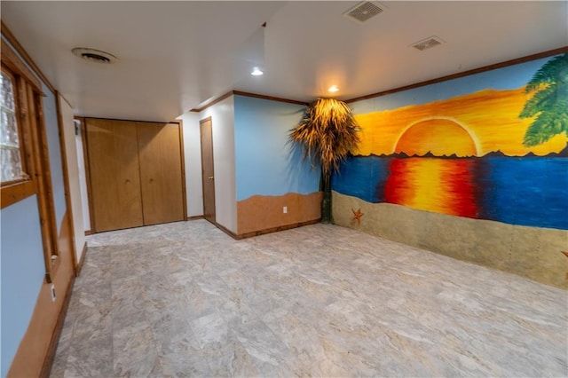 interior space featuring crown molding, baseboards, and visible vents