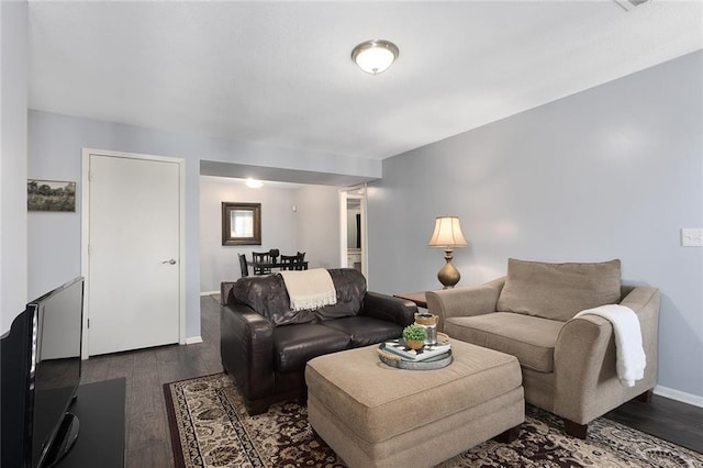 living room featuring wood finished floors and baseboards