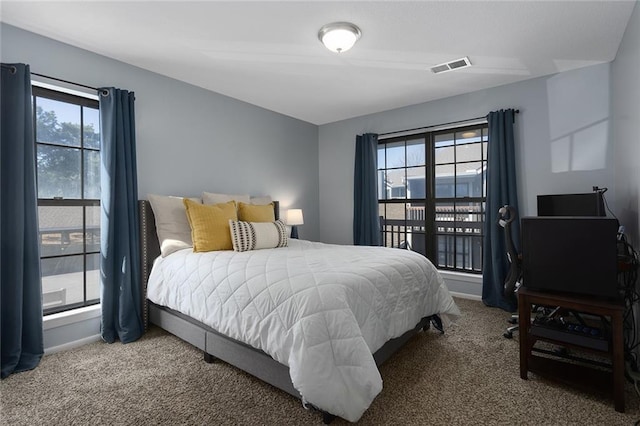 bedroom with baseboards, visible vents, and carpet floors