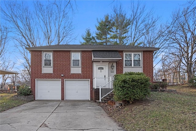 bi-level home featuring brick siding, concrete driveway, and an attached garage