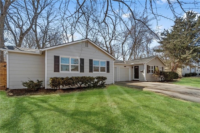 ranch-style house with an attached garage, concrete driveway, and a front lawn