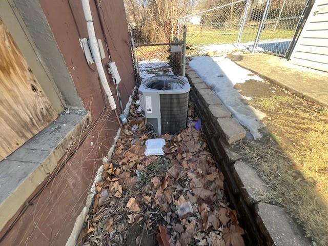 details featuring central air condition unit and fence