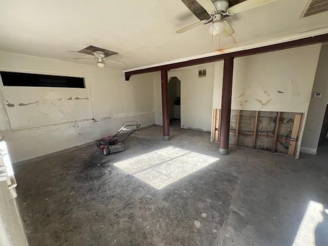 spare room with a ceiling fan, visible vents, and arched walkways