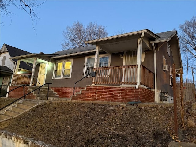 view of front of house with covered porch and stucco siding