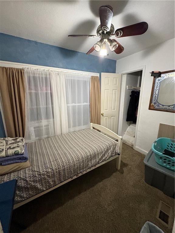 carpeted bedroom featuring baseboards and ceiling fan