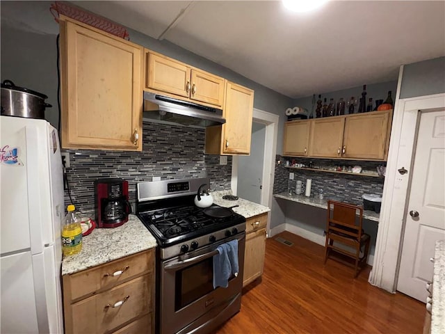 kitchen with light brown cabinets, under cabinet range hood, wood finished floors, freestanding refrigerator, and stainless steel gas range