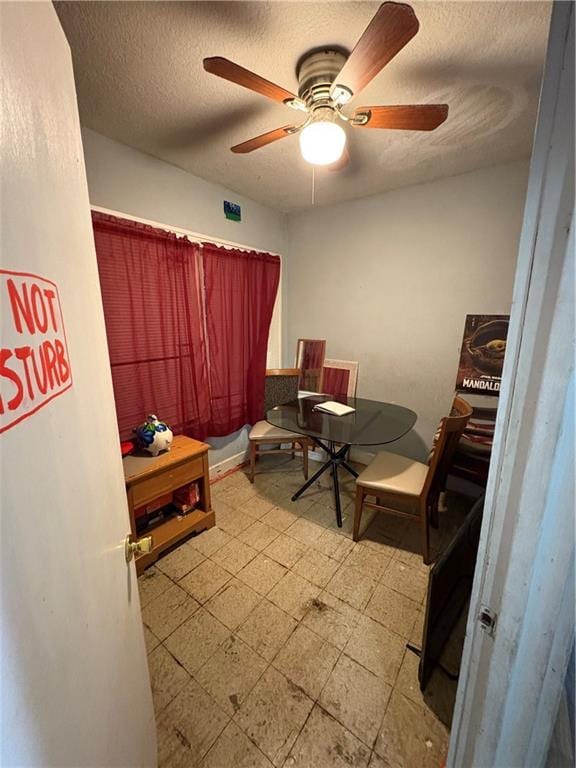 office area with tile patterned floors, a ceiling fan, and a textured ceiling