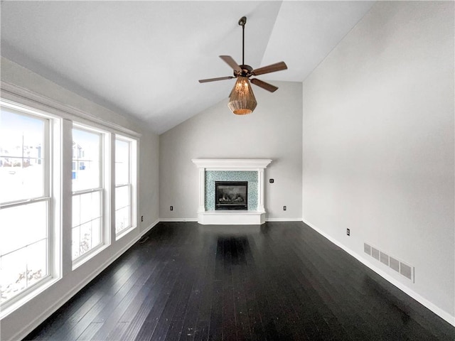 unfurnished living room with visible vents, a fireplace, baseboards, dark wood-style flooring, and vaulted ceiling