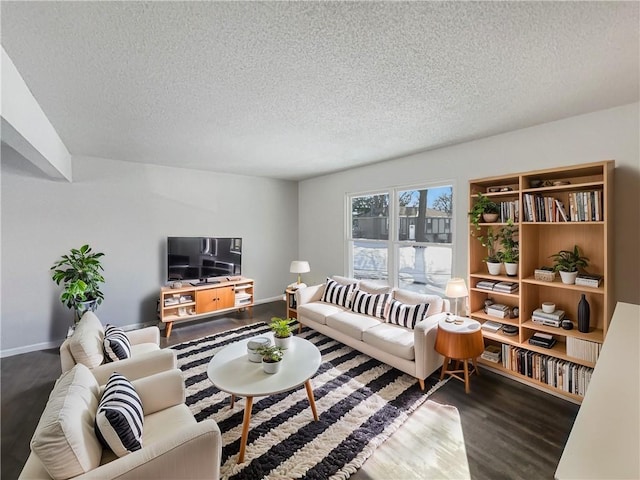 living room featuring a textured ceiling, dark wood-type flooring, and baseboards