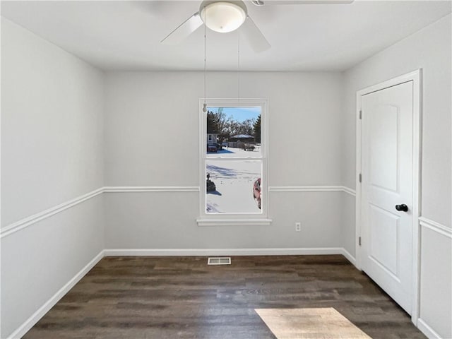 empty room featuring visible vents, ceiling fan, baseboards, and wood finished floors