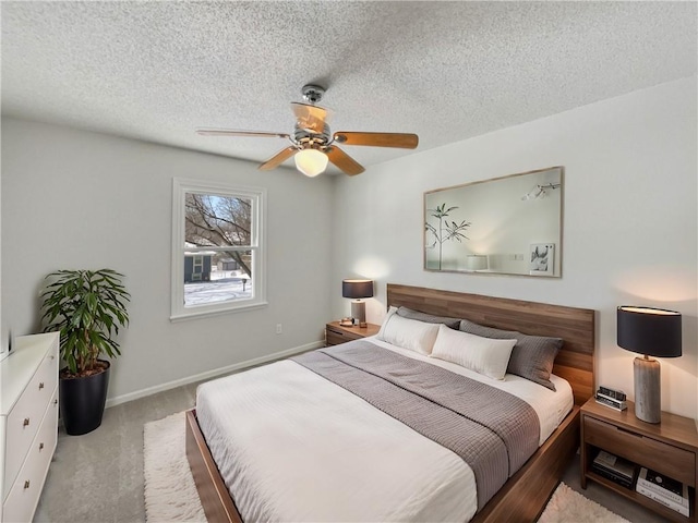 bedroom with baseboards, carpet floors, and a textured ceiling