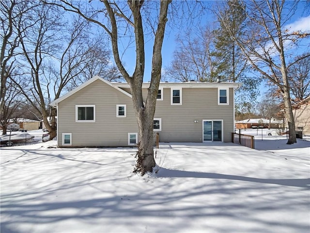 view of snow covered rear of property