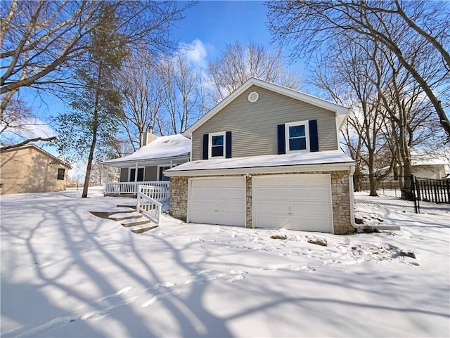 view of front facade featuring fence, an attached garage, covered porch, a chimney, and stone siding