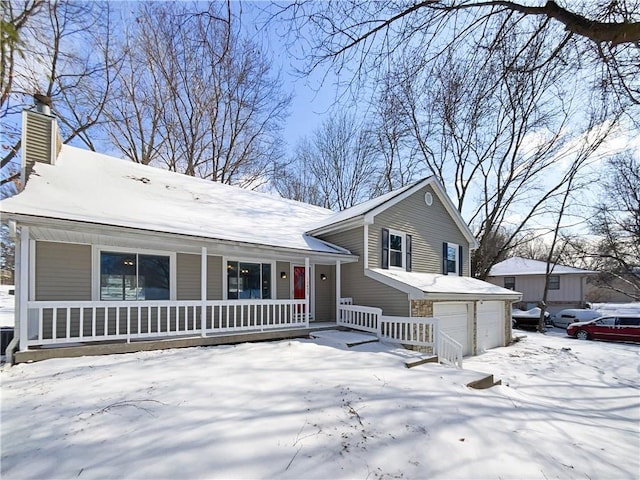 tri-level home featuring covered porch, a chimney, and a garage