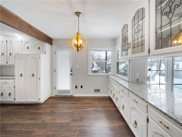 kitchen with dark wood finished floors, white cabinetry, glass insert cabinets, and light stone counters