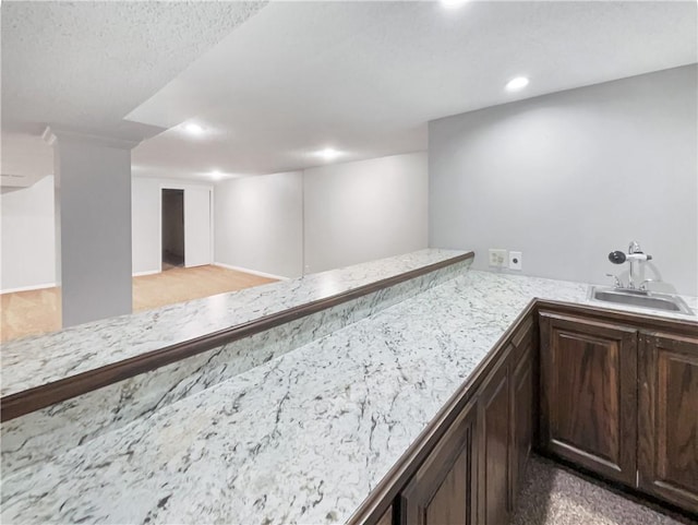 bar featuring indoor wet bar, recessed lighting, and a sink