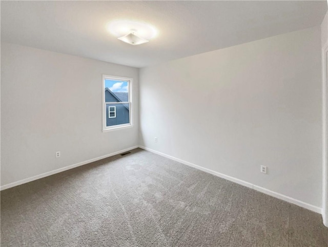 spare room featuring visible vents, baseboards, and carpet floors