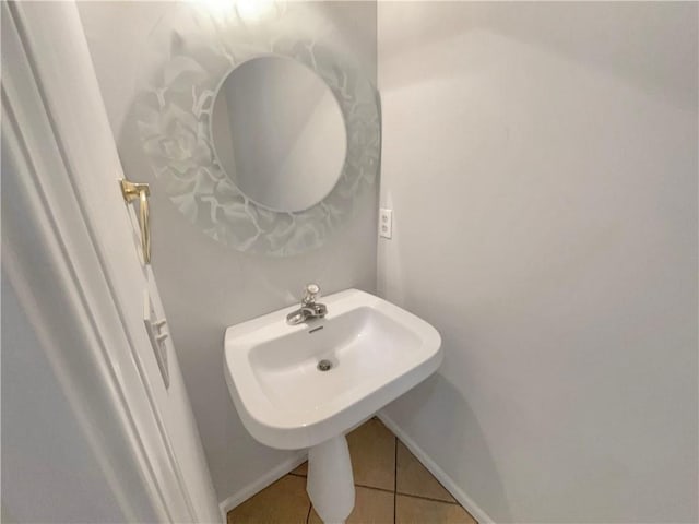 bathroom with tile patterned floors and baseboards